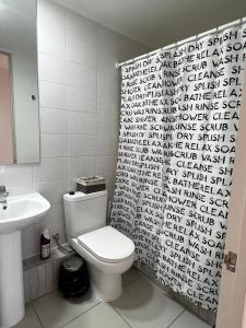 Un baño con inodoro y cortina de ducha en En MACHALI Tranquilidad y comodidad Parcking wifi, en Rancagua
