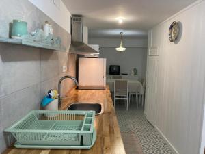 a kitchen with a sink and a counter top at Melro-d' água in Manteigas
