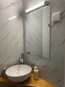 een badkamer met een witte wastafel en een spiegel bij Melro-d' água in Manteigas