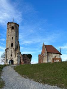 an old building and a church on a hill at Podroom LauMarYvo in Dugo Selo