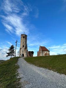 an old church on top of a grassy hill at Podroom LauMarYvo in Dugo Selo
