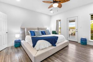 a bedroom with a bed and a couch with blue pillows at The Tree House on Lake Brownwood in Brownwood