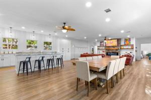 a kitchen and dining room with a wooden table and chairs at The Tree House on Lake Brownwood in Brownwood +97 photos