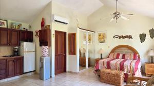 a bedroom with a bed and a refrigerator at Ocean Dream 1st See Line Studio in Cabarete