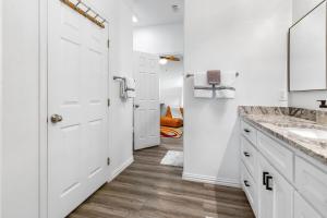 a white bathroom with white cabinets and a sink at The Tree House on Lake Brownwood in Brownwood +97 photos
