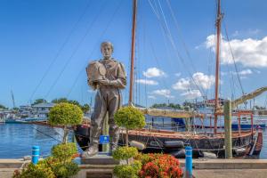 a statue of a man standing in front of a boat at Luxury Family Beach Escape with Heated Pool and Putting Green in Tarpon Springs