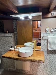 a bathroom with a sink and a mirror at Victoria Tiny Stone House in Ponta do Pargo +35 photos
