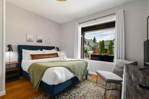 a bedroom with a large bed and a window at Downtown Home Walk to Restaurants and Waterfront in Tacoma