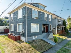 a gray house with a front yard at Downtown Home Walk to Restaurants and Waterfront in Tacoma