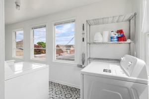 a white bathroom with a sink and a window at Downtown Home Walk to Restaurants and Waterfront in Tacoma +54 photos