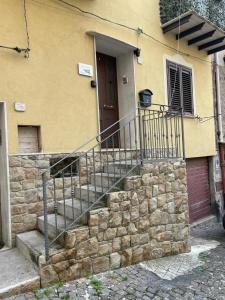 a stone staircase leading to a house with a door at Sicilia Bedda Casa Vacanze in Lascari +16 photos
