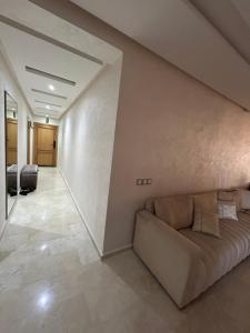 a living room with a couch and a hallway at Rabat Explorer Apartment in Rabat