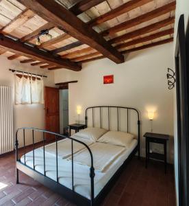 a bedroom with a bed in a room at Casa Ripa North in Cupramontana +8 photos