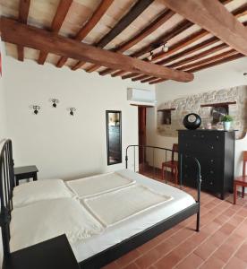 a bedroom with a bed and a wooden ceiling at Casa Ripa North in Cupramontana