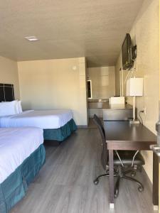 a hotel room with two beds and a desk at Executive inn in Crystal City