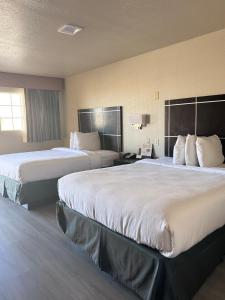 a hotel room with two beds and a phone at Executive inn in Crystal City