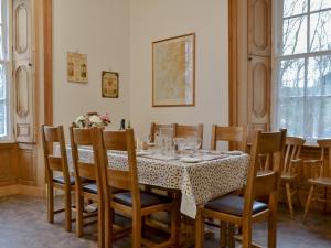 a dining room with a table and chairs at The Factors House - 25752 in Kilmartin