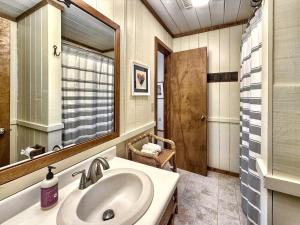 a bathroom with a sink and a mirror at Karma Cabin in Scaly Mountain +32 photos