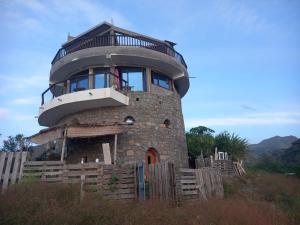 Un edificio redondo con balcón en la parte superior. en Casa Fabrice, en Ribeira da Prata