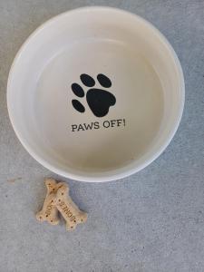 a white frisbee with paws off written on it at House in Restful Setting in Whangarei