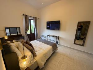 a bedroom with a bed and a person in a mirror at Cipresso en ValQuirico in Santeagueda