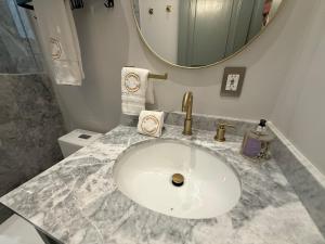 a bathroom with a white sink and a mirror at Cipresso en ValQuirico in Santeagueda +29 photos