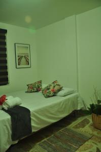 a bedroom with a bed with two pillows on it at live Medellín desde un Apartamento Céntrico y Cómodo in Medellín +26 photos