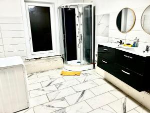 a white bathroom with a shower and a sink at Christalsuite in Frameries