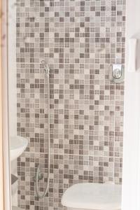 a bathroom with a shower with a toilet and a sink at Pousada Panceiro in Cabo Frio +33 photos