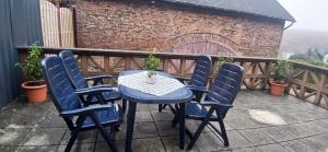a blue table and chairs on a patio at Ferienwohnung Alte Scheune in Westerburg