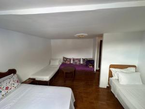 a room with two beds and a couch at Nouara Appart'Hotel in Chefchaouen