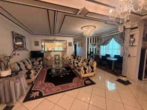 a living room with couches and a chandelier at Tradicional & Luxury Apartment City Center & Beach & WiFi! in Tangier