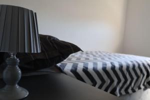 a lamp sitting on a table next to a pillow at Apartmani Ana in Čapljina +3 photos