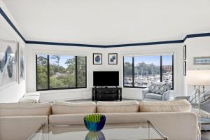 a living room with a couch and a tv at 236 Captains Quarters in Hilton Head Island +76 photos