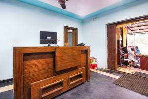 a large wooden door with a television on top at Hotel O Sai Residency Near SR Nagar metro station in Hyderabad