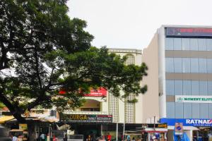 a city street with a tree and a building at Hotel O Sai Residency Near SR Nagar metro station in Hyderabad
