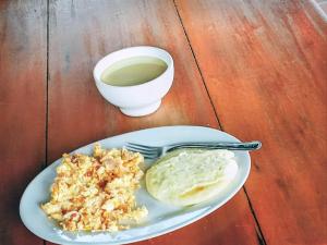 a plate of food with rice and a cup of coffee at Hostal el Profe in Capurganá +28 photos