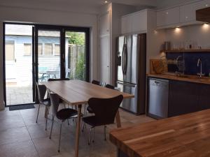 a kitchen with a wooden table and chairs in it at Lapwing in Yarmouth