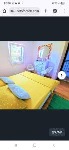 a bedroom with a yellow bed and a mirror at Apartmani Aurelia in Veliki Drvenik +8 photos