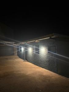 a brick building with lights on it at night at Les secrets de l Esch in Jezainville +9 photos