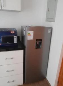 a silver refrigerator in a kitchen next to a counter at Apartment with Beach Exit 204 in Punta Negra