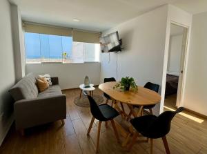 a living room with a couch and a table at Apartment with Beach Exit 204 in Punta Negra
