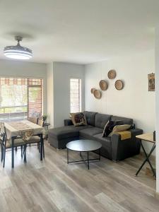a living room with a couch and a table at Entire Apartment in Eldoraigne, Centurion in Eldoraigne
