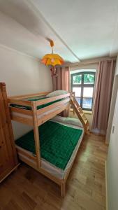 two bunk beds in a room with a window at Oben im Selketal in Harzgerode