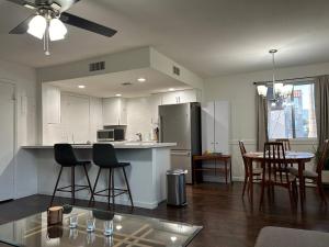 a kitchen with white cabinets and a table and chairs at Desert Dwelling Resort Near Papago Park in Phoenix