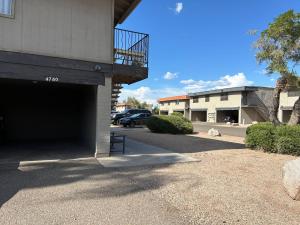 a parking lot of a building with a garage at Desert Dwelling Resort Near Papago Park in Phoenix