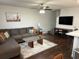 a living room with a couch and a flat screen tv at Desert Dwelling Resort Near Papago Park in Phoenix