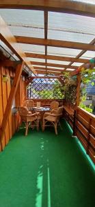 a patio with a table and chairs and a stained glass window at 4 Bett Ferienwohnung Weintraube in Wengenroth