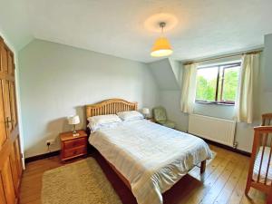 a bedroom with a large bed and a window at Fox Cottage - E4510 in Chipping Sodbury