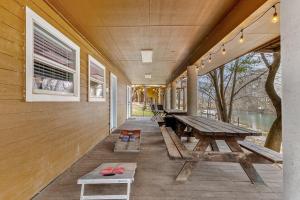 a porch with a picnic table and benches on it at Earth Haus in Fourth Crossing